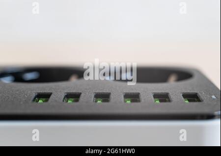 Modern convenient multi-port usb charger for devices. Close-up of a power outlet. Macro. Stock Photo