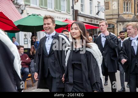 Picture dated  July 1st 2021 shows students from  Queens’  Cambridge on their graduation day which has returned after the ceremony was cancelled last year due to the Coronavirus pandemic.  Students dressed in black gowns as the traditional Cambridge University graduation ceremonies took place – after they were cancelled last year due to the Coronavirus pandemic. The students paraded into historic Senate House to collect their degrees from the prestigious university. Family and friends would normally watch the ceremony inside the Senate House, but this year they had to wait outside due to Covid Stock Photo