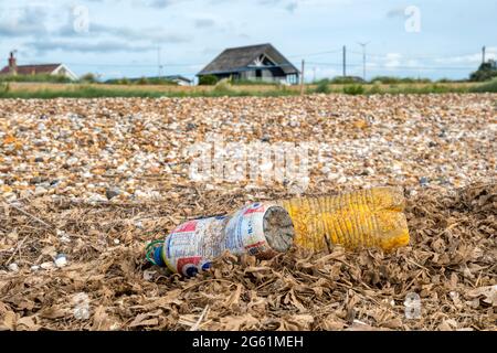 Plastic drinks bottles washed up on the high tide line on the shore of the Wash in Norfolk. Stock Photo