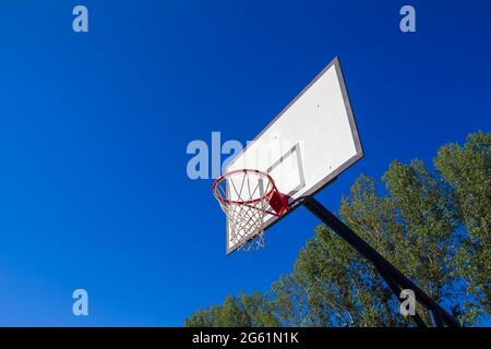 White basketball board on clear blue sky background. Street sport concept, copy space Stock Photo