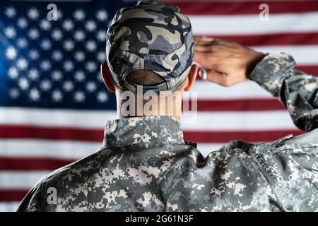 US Army Military Soldier Veteran Against Flag Stock Photo