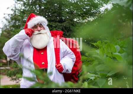 Santa Claus in a protective suit outdoors during the coronavirus epidemic Stock Photo