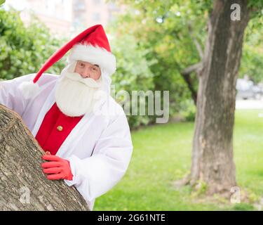 Santa claus in a protective suit during the coronavirus outdoors Stock Photo