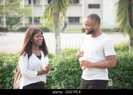 young people taking cups of smoothie outdoor,young people chilling outdoor Stock Photo