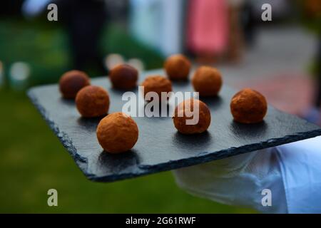 Chocolate Truffles close-up on black stone. Shallow dof Stock Photo