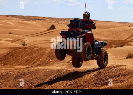 Quad Bike for Off Road Extreme Racing gets over the difficult part of the route during the Rally raid in sand. THE GOLD OF KAGAN-2021. 26.04.2021 Stock Photo