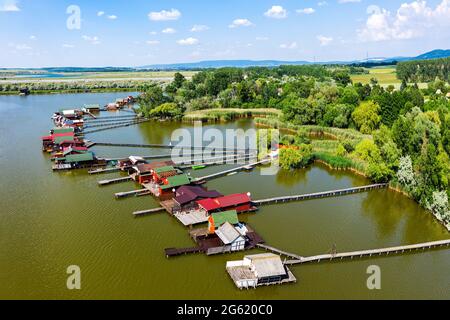 Aerial view of the famous Bokod Floating Village with piers and traditional wooden fishing cottages built on the lake Bokodi. Stock Photo