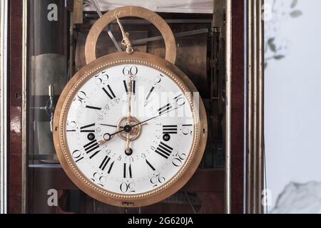 Vintage grandfather clock with white clock face. Close up photo Stock Photo