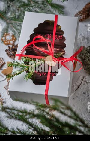 Classic French eclair with custard in chocolate glaze. Dessert is decorated with freeze-dried raspberries and strawberry chocolate. Delicious and beau Stock Photo