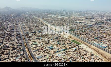 Aerial view of the district of San Martin de Porres and the Rimac river located north of the capital of Lima Stock Photo