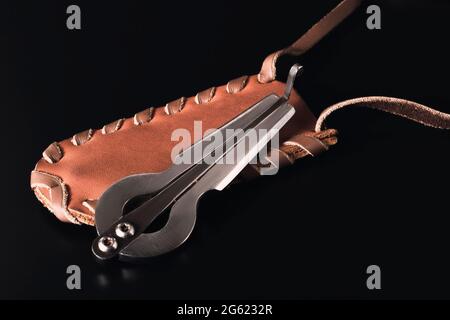 The harp compass lies on a leather case. Dark background. Stock Photo