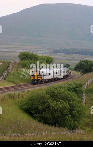 Two Northern class 158 dmu's seen between Ribblehead viaduct and Blea Moor signal box on the Settle to Carlisle line on Thursday 1st July 2021. Stock Photo