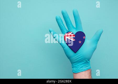 New Zealand medical health heart. Nurse hand holding country heart flag Stock Photo