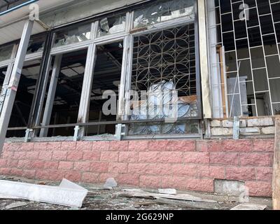 Close up of broken windows in old building. Windows with broken glasses in abandoned brick building. Concept of street riots Stock Photo