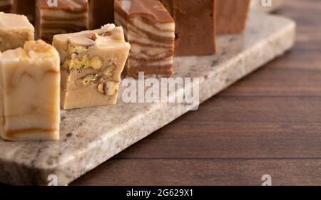 Six Different Flavors of Fudge on a Wooden Table Stock Photo