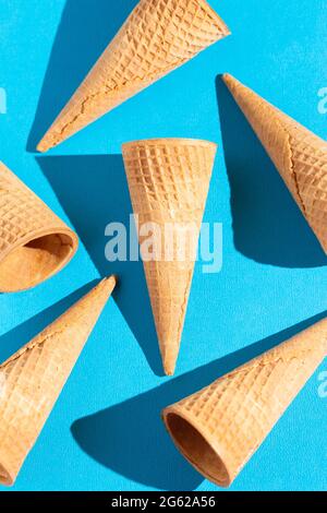 Waffle ice cream cones with shadow on a blue background Stock Photo - Alamy
