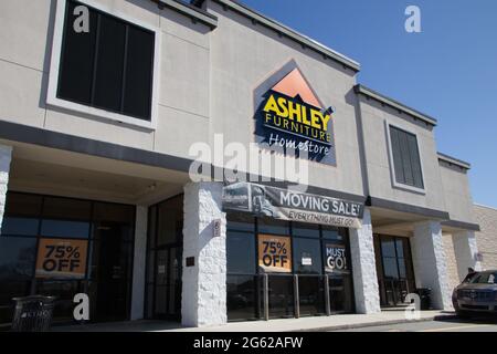 Augusta, Ga USA - 03 04 21: Ashley Furniture retail store exterior entrance sign and people - Robert C Daniel Parkway Stock Photo
