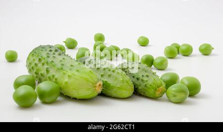 Cucumbers and peas isolated on white background Stock Photo