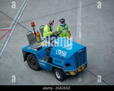 Medellin, Antioquia, Colombia - May 17 2021: Latin Men Parking a Blue Car at the Side of the Airport Stock Photo