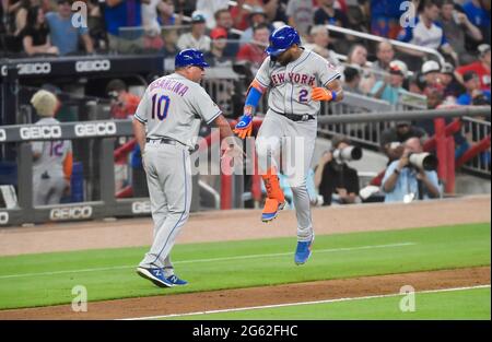 New York Mets hitting coach Eric Chavez, left, talks with Pete Alonso,  right, in the dugout before a spring training baseball game against the  Houston Astros, Monday, April 4, 2022, in West