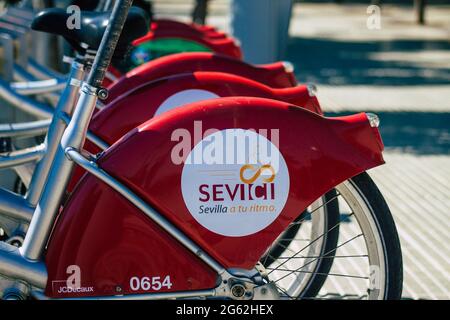 Seville Spain July 01, 2021 Accessible bicycles to hire for short periods of time, usually for a few hours parked in the street and part of the public Stock Photo