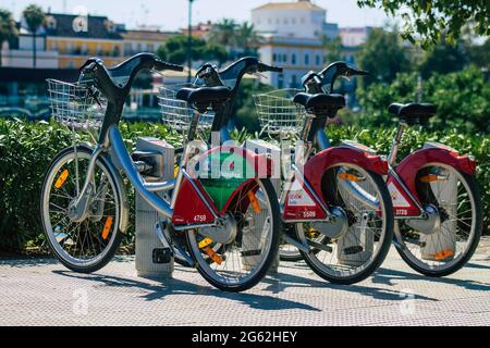 Seville Spain July 01, 2021 Accessible bicycles to hire for short periods of time, usually for a few hours parked in the street and part of the public Stock Photo