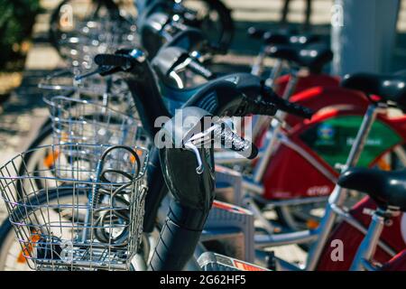 Seville Spain July 01, 2021 Accessible bicycles to hire for short periods of time, usually for a few hours parked in the street and part of the public Stock Photo