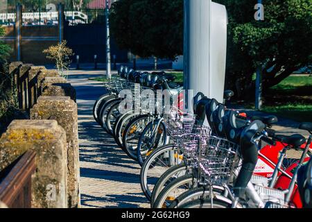 Seville Spain July 01, 2021 Accessible bicycles to hire for short periods of time, usually for a few hours parked in the street and part of the public Stock Photo