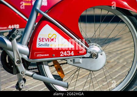 Seville Spain July 01, 2021 Accessible bicycles to hire for short periods of time, usually for a few hours parked in the street and part of the public Stock Photo