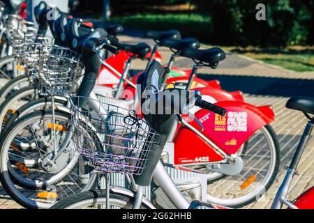 Seville Spain July 01, 2021 Accessible bicycles to hire for short periods of time, usually for a few hours parked in the street and part of the public Stock Photo