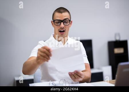 Happy Man Reading Exam Letter With Exam Results Stock Photo