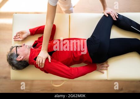 Masseuse Doing Seated Shoulder Massage For Businessman Stock Photo, Picture  and Royalty Free Image. Image 114325390.