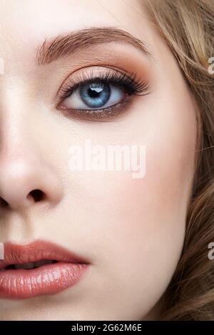 Closeup macro shot of blue human female eye. Woman with natural vogue face beauty makeup. Stock Photo