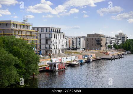 Berlin, Germany. 21st June, 2021. Shells and finished new buildings stand near Spandau's Wasserstadtbrücke bridge on the banks of the Havel. By 2025, a new district with around 2,500 apartments, playgrounds, daycare centers, shops, restaurants and supermarkets is to be built on the riverbank. Credit: Soeren Stache/dpa-Zentralbild/ZB/dpa/Alamy Live News Stock Photo