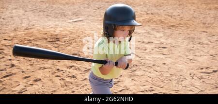 Child baseball player focused ready to bat. Kid holding a baseball bat. Stock Photo