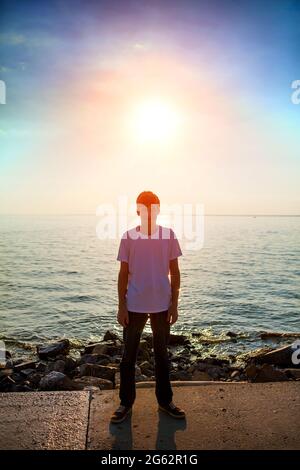 Toned Photo of Person Silhouette on the Sea Background Stock Photo