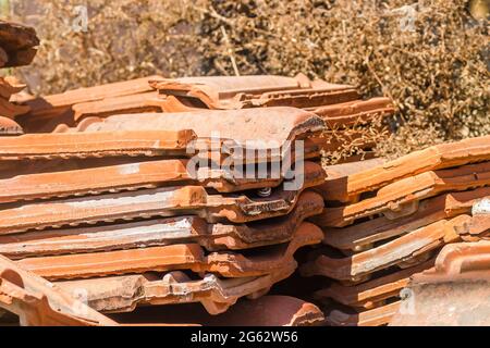 A pile of old tiles, removed from the roof of the house. Stock Photo