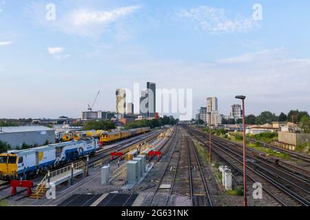 The railway and skyline with skyscraper tower blocks of the mixed use Victoria Square development in the town centre of Woking, Surrey, SE England Stock Photo