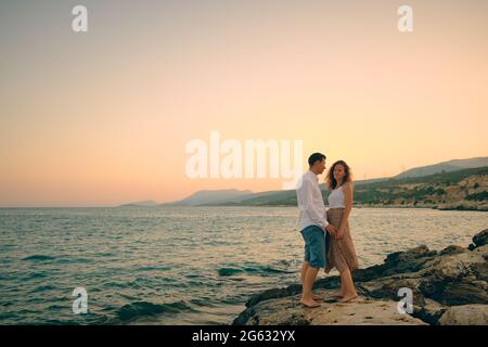 Couple on an evening seaside date Stock Photo