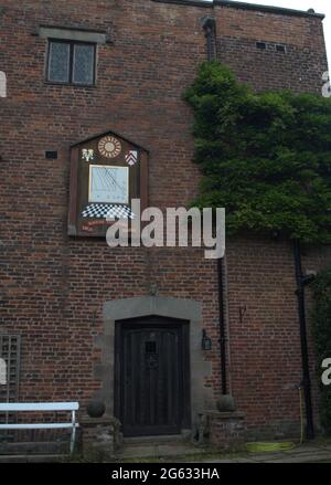 Side entrance to Gawsworth Hall featuring the Sundial hanging above the door Stock Photo