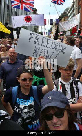 London, UK. 26th June, 2021. Protesters hold placards during the demonstration.Anti-lockdown and anti-vaccination demonstrators held a protest against further lockdowns, masks and vaccination passports. Credit: Martin Pope/SOPA Images/ZUMA Wire/Alamy Live News Stock Photo