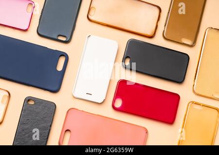 Pile of multicolored plastic back covers for mobile phone. Choice of smart phone protector accessories on neutral background. A lot of silicone phone Stock Photo