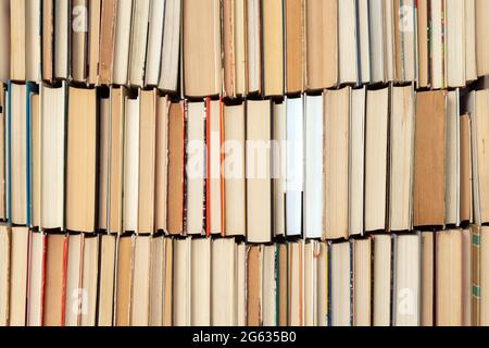 Vintage book background. Old and used hardback books stacked next to each other. Concept of education and studying. Nobody Stock Photo