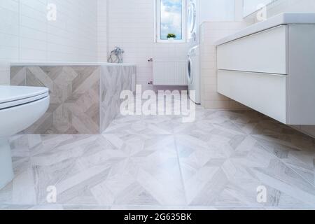 Bathroom after renovation. New stone tiles on the bath room floor. Home renovation and improvement concept. Nobody Stock Photo