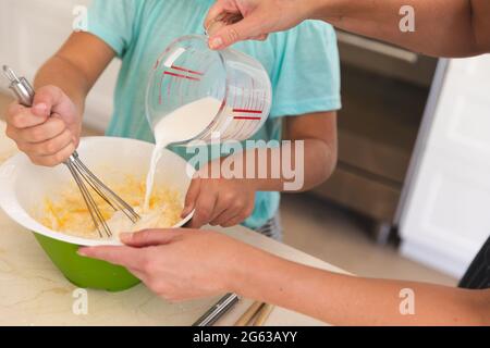 Caucasian father and son baking together in kitchen Stock Photo