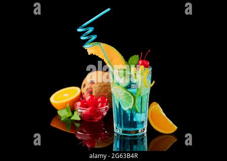 Blue Lagoon cocktail with a slice of melon and cherry isolated on white