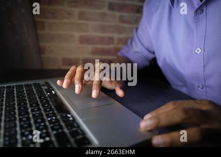 young man working on laptop stealing personal data  Stock Photo