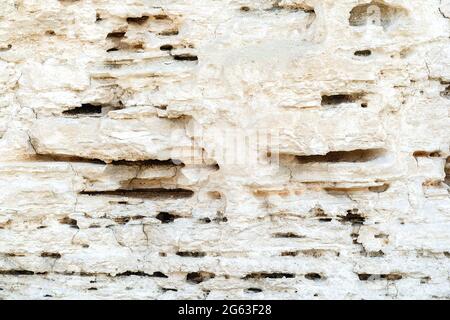 Beautiful natural cliff surface white limestone background. Multiple layer rock pattern with horizontal lines. Great texture for your design. Copy spa Stock Photo