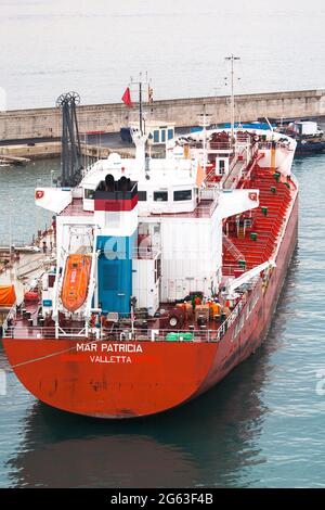 Oil tanker alongside oil terminal Palma Harbour Mallorca. Deck hands busy at work aft. Stock Photo