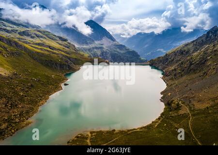 Aerial view of dam in inspiring alpine mountains Stock Photo